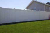 tall pvc vinyl privacy fence in backyard