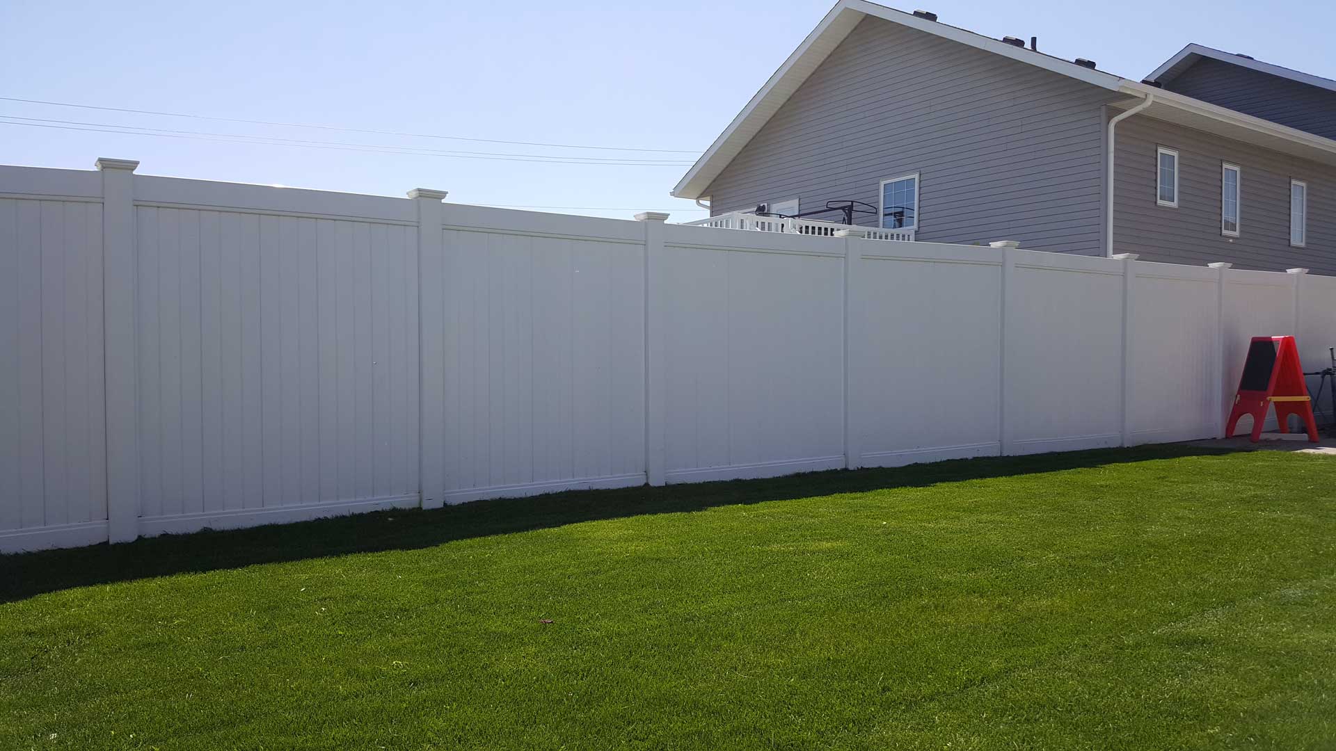 tall pvc vinyl privacy fence in backyard