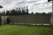 pvc vinyl privacy fence with door surrounding backyard