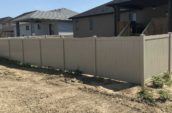 under construction area with home surrounded by pvc privacy final fence