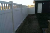 pathway to front yard from backyard surrounded by pvc vinyl privacy fence