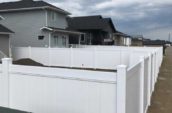 pvc vinyl privacy fence surrounding home backyard