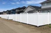 set of three homes with jasper pvc vinyl privacy fences surrounding their backyards