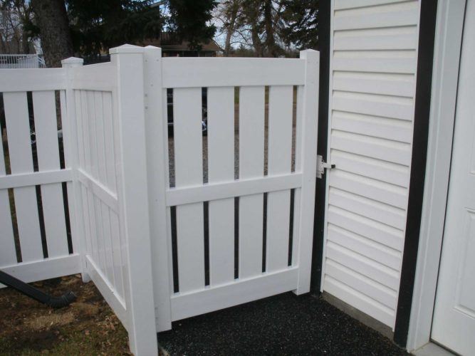 semi-privacy vinyl fence door attached to home