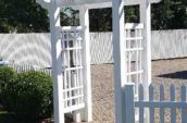 vinyl fence accessories entrance above stone pathway