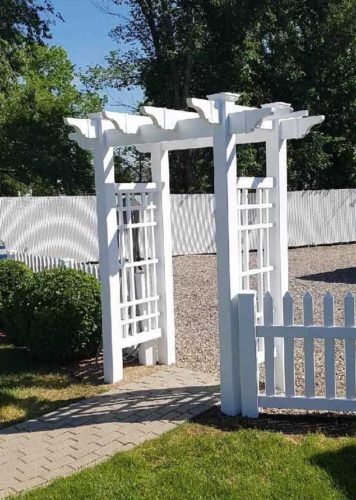 vinyl fence accessories entrance above stone pathway